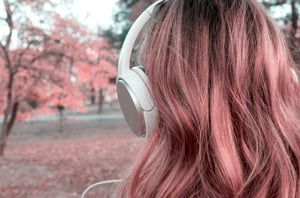 Back-of-woman-head-with-big-white-earphones-looking-autumn-tree.Close-up--hair-and-music-earphone-1125801078_2131x1411